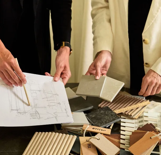 Architect reviewing detailed drawings and material samples