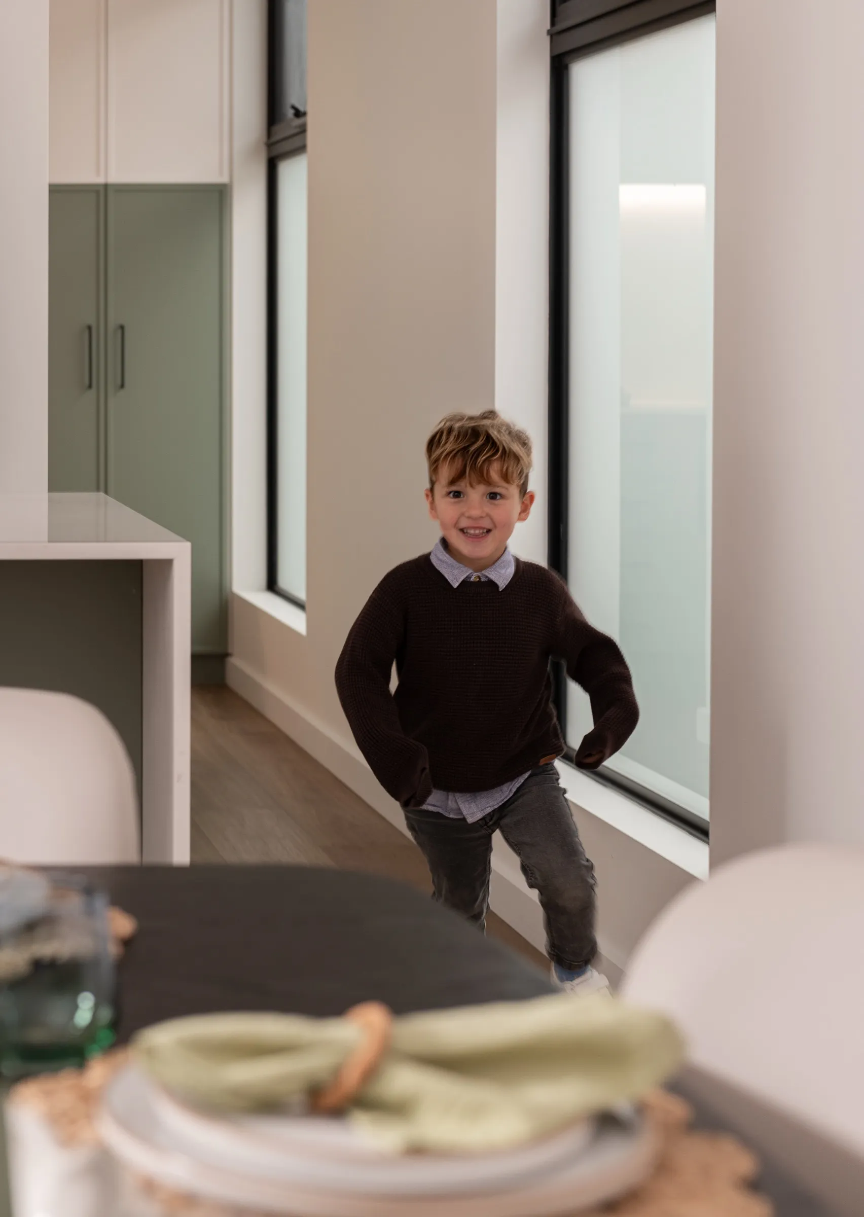 Boy running through the kitchen