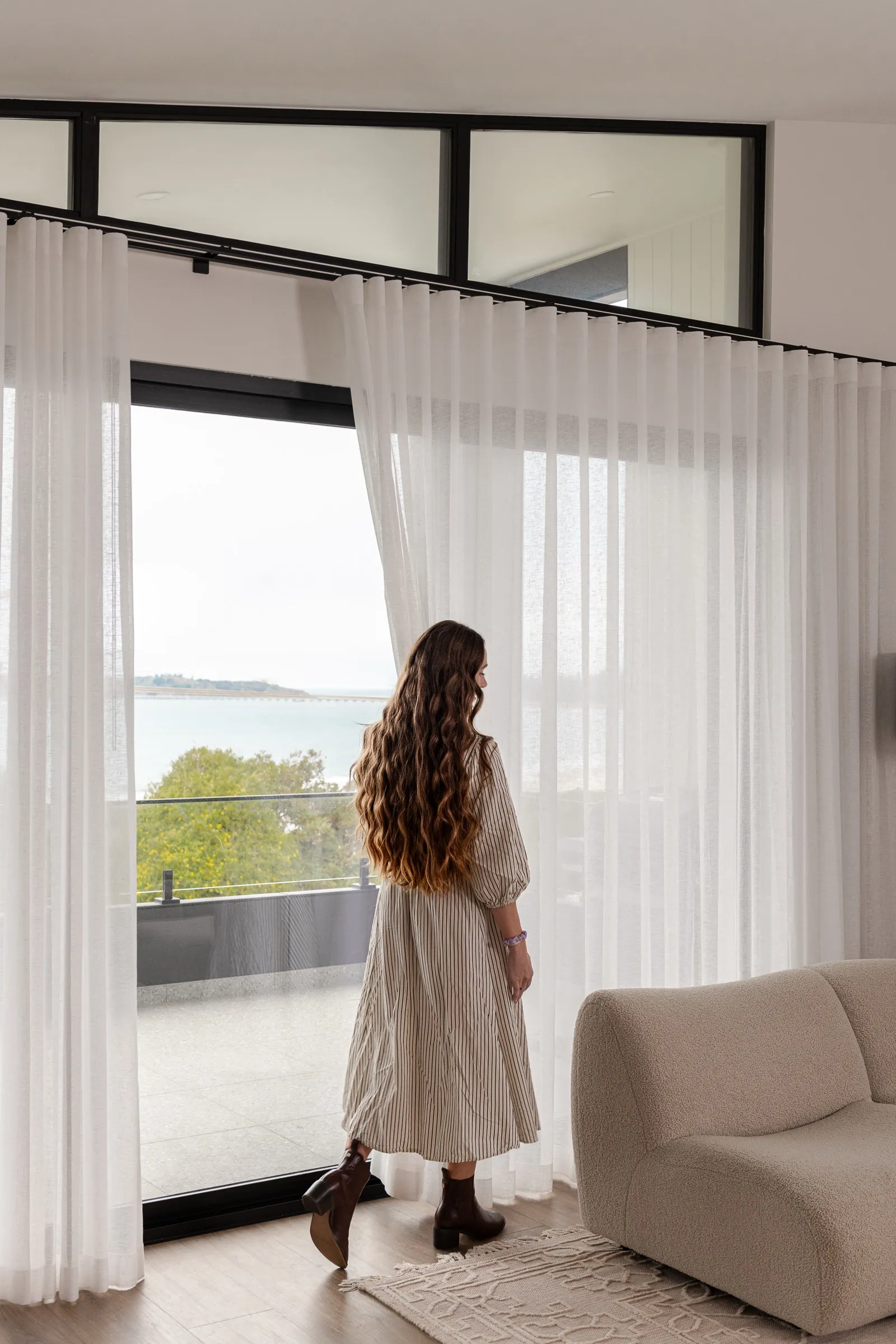 Woman by the window with an ocean view